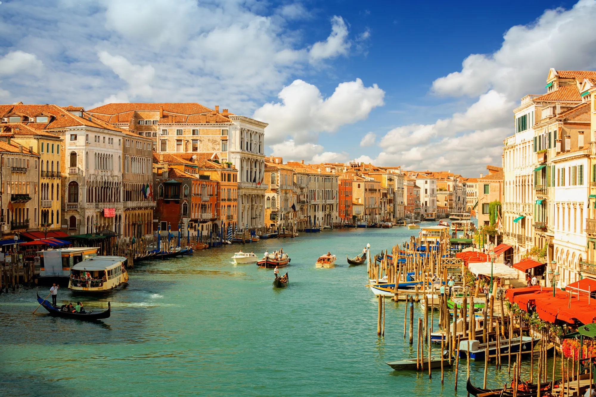 Gondolas and boats on Grand Canal with historic Venetian palaces
